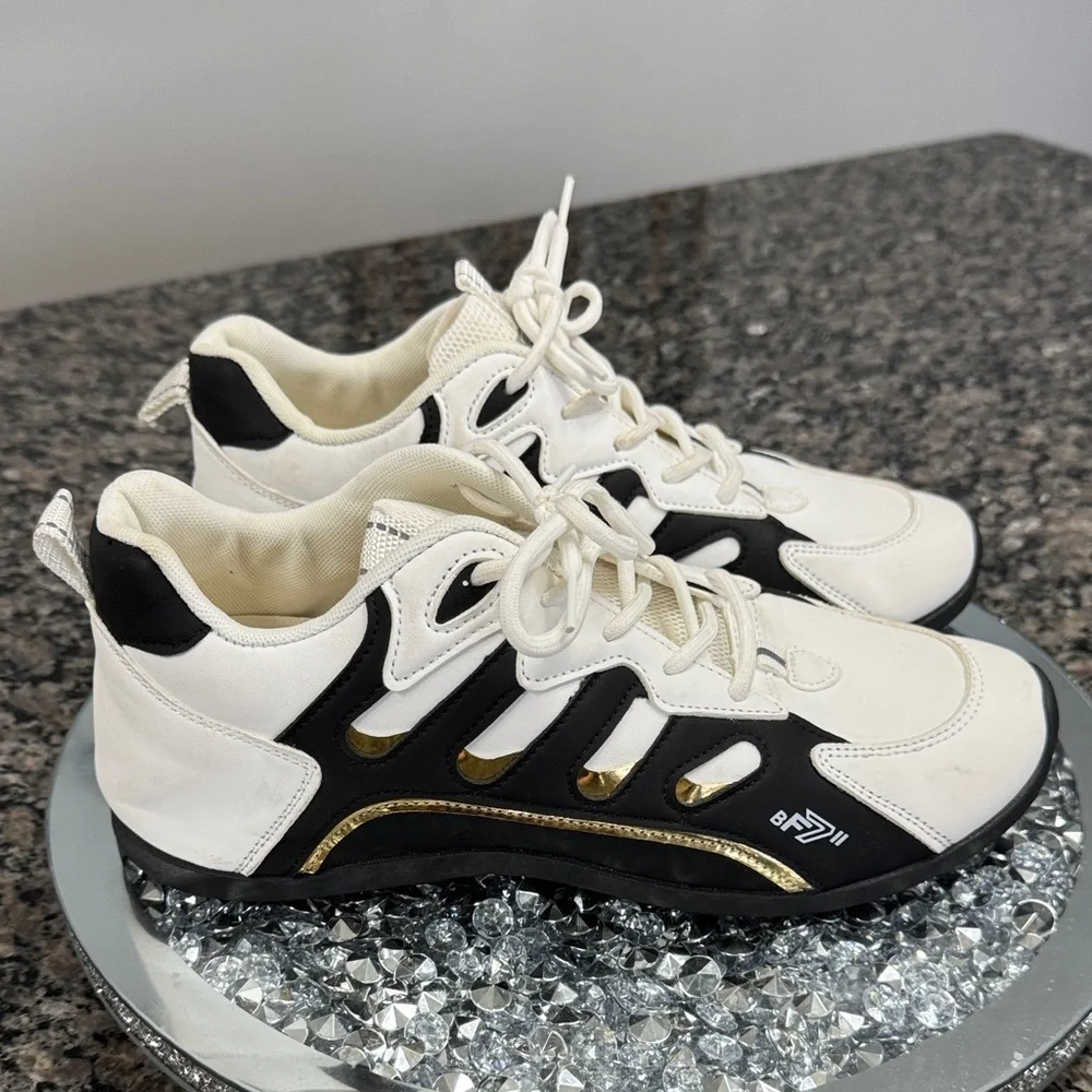 White and Black womens fashion Sneakers with gold accents EUC 10